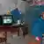 Пожилая жительница Донбасса в комнате с телевизором