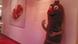 A life-sized currywurst mascot leans against a wall A life-sized currywurst mascot leans against a wall