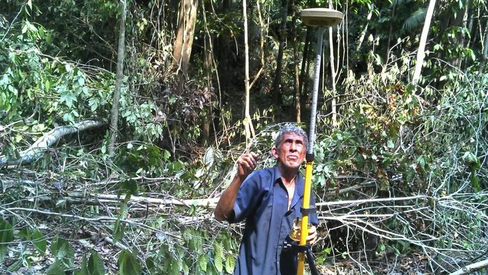 A man using GPS in the rain forest to mark coordinates 