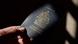 A hand holds a Canadian passport A hand holds a Canadian passport