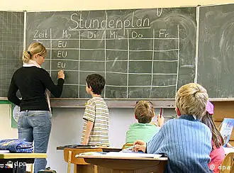 Students and a teacher work at a blackboard