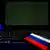 Российский флаг на фоне компьютерной клавиатуры