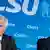 Seehofer and Söder look very unhappy in front of a CSU sign