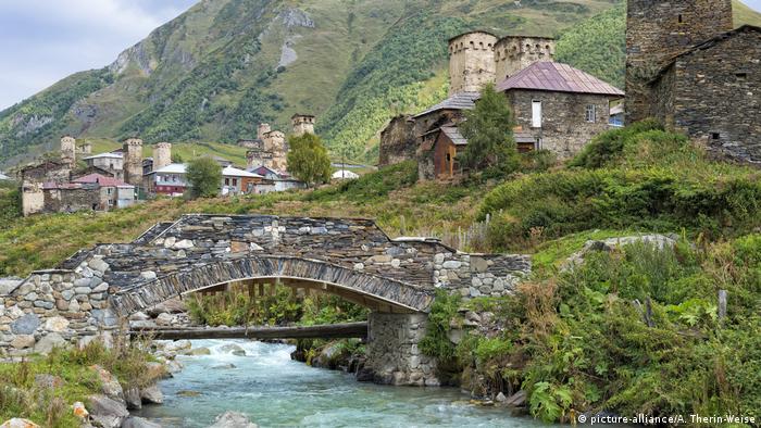 Traditional medieval Svanetian tower houses, Stone bridge over Patara Enguri River, Ushguli village, Svaneti region, Caucasus, Georgia 
