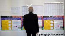 A man looks at a list of candidates at a polling station in Sarajevo on October 7, 2018 as Bosnia and Herzegovina holds it's general elections. - Bosnians started voting for leaders who will steer the future of their poor and splintered nation, where politicians are still fanning the divisive nationalism that fuelled its 1990s war. (Photo by ANDREJ ISAKOVIC / AFP) (Photo credit should read ANDREJ ISAKOVIC/AFP/Getty Images)