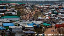 KUTUPALONG, BANGLADESH - AUGUST 27: Many Rohingya are seen along the road where a market is in Kutupalong camp August 27, 2018 in Kutupalong, Cox's Bazar, Bangladesh. UN investigators said on Monday that Myanmars army had carried out genocide against the Rohingya in Rakhine state and that its top military figures must be investigated for crimes against minorities across the country. The UN report accused Myanmars military for murders, imprisonments, enforced disappearances, torture, rapes and other forms of sexual violence in Rakhine state, all of which constitute crimes against humanity, as a wave of violence forced more than 720,000 Rohingya to flee into the Coxs Bazar district of Bangladesh one year ago. (Photo by Paula Bronstein/Getty Images)