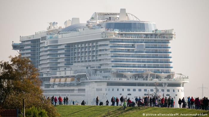 People watching the AIDAnova cruise ship sail