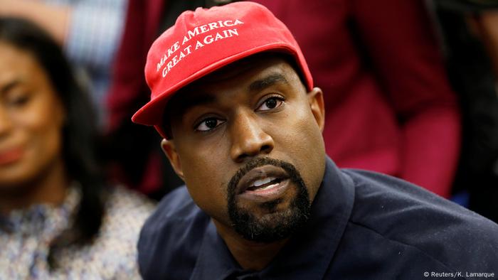 Kanye West wears a red cap with a Make America Great Again slogan