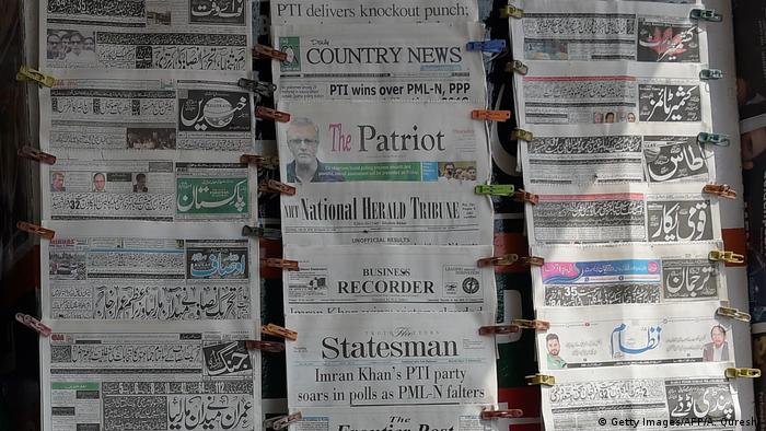Newspapers are seen at a stall in Islamabad