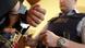 A police reaches towards a pair of handcuffed hands A police reaches towards a pair of handcuffed hands