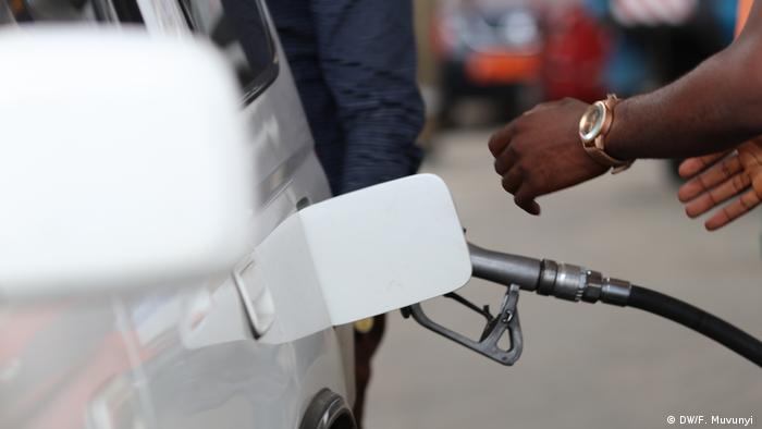 A motorist pumps fuel into a car