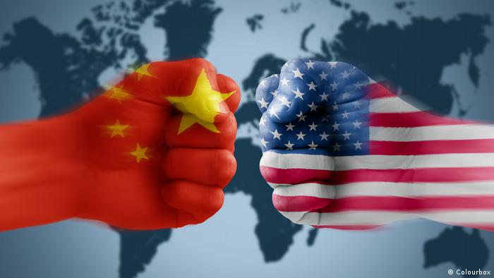 Two fists showing US, China flags