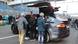 People gather round a Tesla vehicle in Lausitz People gather round a Tesla vehicle in Lausitz