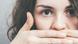 Woman with hands in front of her face Woman with hands in front of her face