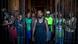 A group of pre-trial detainees in Madagascar stand behind half-opened prison bars, facing the cameria A group of pre-trial detainees in Madagascar stand behind half-opened prison bars, facing the cameria