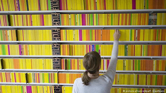 a person selects a yellow book
