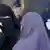 Two women wearing niqabs