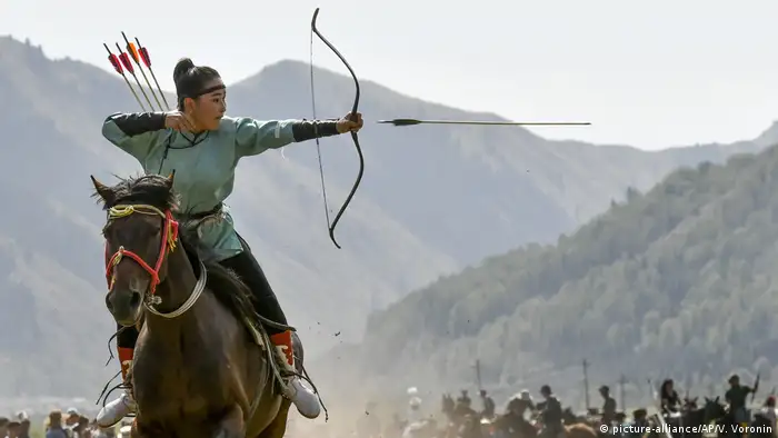 A women releases an arrow during an archery competition during the Third Nomad Games in Kyrgyzstan.