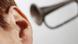 A trumpet held up to an ear A trumpet held up to an ear
