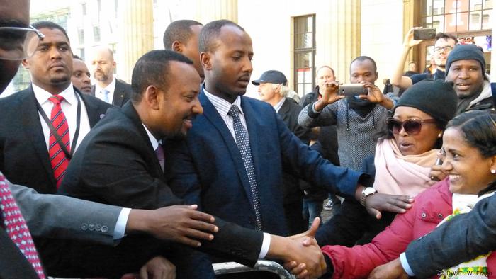 Abiy Ahmed shaking hands with people in a crowd during his visit to Germany in 2018