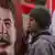 Мужчина рядом с портретом Сталина