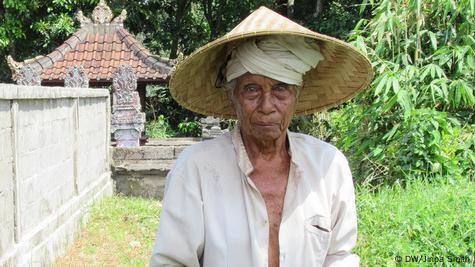 Old Balinese Farmer With Wrinkled Face In Traditional Straw Hat