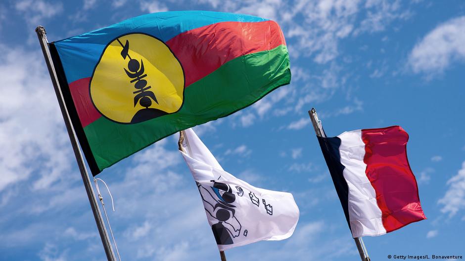 The Kanak and French flags fly in New Caledonia