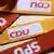 CDU and SPD logos printed on yellow and red cloth straps
