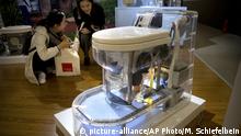 Visitors look at a model of a self-contained toilet at the Reinvented Toilet Expo in Beijing, Tuesday, Nov. 6, 2018. With a jar of human feces on a podium next to him, billionaire philanthropist Bill Gates has kicked off a Reinvented Toilet Expo in China. Gates said Tuesday that the technologies on display at the three-day expo in Beijing represent the most significant advances in sanitation in nearly 200 years. (AP Photo/Mark Schiefelbein) |