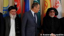 Head of Afghanistan delegation and Deputy Chairman of High Peace Council, Hajji Din Mohammad, Russian Foreign Minister Sergei Lavrov and Sher Mohammad Abbas Stanakzai, head of the Taliban’s political council in Qatar, pose for a family photo during the multilateral peace talks on Afghanistan in Moscow, Russia November 9, 2018. REUTERS/Sergei Karpukhin
