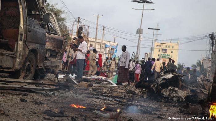 People gather at the scene of a bomb explosion in Mogadishu