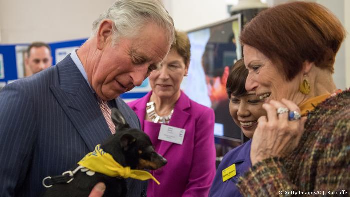 Prince Charles holding a dachshund
