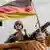 A German flag flies above a Bundeswehr soldier in Mali