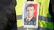 A yellow vest demonstrator has a picture of Macron on it with the word, 'dictator' under his face (Reuters/C. Platiau)