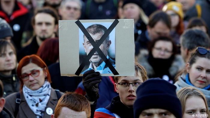 A placard with Babis' face crossed out