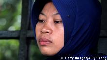 Baiq Nuril Maknun, who exposed her cheating boss, looks stunned after she got slapped with a six-month jail term for violating a controversial law against spreading indecent material, in Mataram on Lombok island on November 16, 2018. - The supreme court's shock decision overturned an earlier court ruling that cleared the woman of breaking the controversial law against spreading indecent material. (Photo by Pikong / AFP) (Photo credit should read PIKONG/AFP/Getty Images)