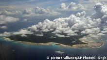 A aerial view of North Sentinel Island, in India's southeastern Andaman and Nicobar Islands, Monday, Nov 14, 2005. The Dec. 26, 2004 tsunami caused by a magnitude 9 earthquake off the coast of Indonesia killed about 3,500 people in Andaman and Nicobar Islands. The tsunami bared ethnic hostilities, destroyed trees, coral and wildlife in a biodiversity hotspot. (AP Photo/Gautam Singh) |