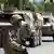 A German soldier stands guard with a convoy of the German military armored vehicles