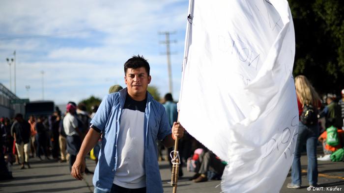 Jose Antonio from Honduras holding white flag