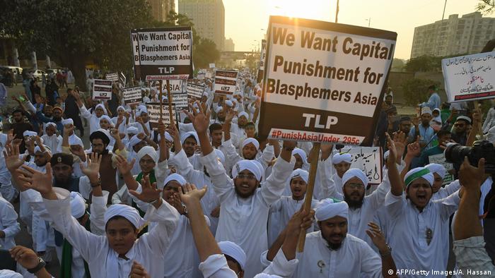 Islamist activists carry placards against Asia Bibi, a Pakistani Christian woman who was recently released after spending eight years on death row for blasphemy, during a rally coinciding with Eid Milad-un-Nabi, which marks the birth anniversary of Prophet Muhammad, in Karachi on November 21, 2018.