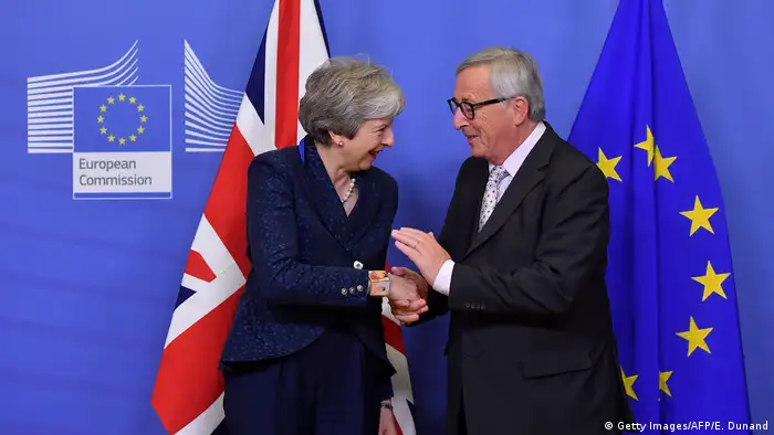 Theresa May and Jean-Claude Juncker shake hands in Brussels (Getty Images/AFP/E. Dunand)