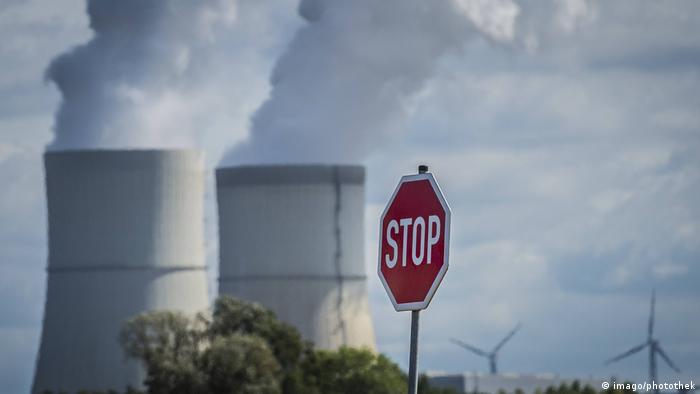 A stop sign in front cooling towers at a coal power station in Germany