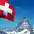 Swiss flag next to the Matterhorn