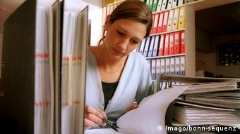 Женщина работает с документацией в офисе