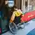 A man in a wheelchair boards a Berlin train