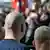 View from behind of a group of skinheads at a march in Dortmund