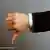 A man's thumb pointing down