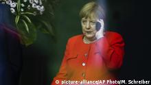 German Chancellor Angela Merkel makes a phone call as the walks through the chancellery to welcome Czech President Milos Zeman for a meeting at the chancellery in Berlin, Germany, Friday, Sept. 21, 2018. (AP Photo/Markus Schreiber) |