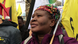 Photo of Makoma Lekalakala at a protest holding a yellow banner Photo of Makoma Lekalakala at a protest holding a yellow banner