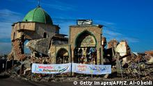 A picture taken on December 16, 2018, shows the Great Mosque of al-Nuri and the remains of Al-Hadba leaning minaret in Mosuls war-ravaged Old City, during the placing of the corner stone ceremony. - The famed 12th century mosque and minaret, dubbed Al-Hadba or the hunchback, were where IS chief Abu Bakr al-Baghdadi made his only public appearance to declare a self-styled caliphate after sweeping into Mosul in 2014. The structures were ravaged three years later in the final, most brutal stages of the months-long fight against IS. (Photo by Zaid AL-OBEIDI / AFP) (Photo credit should read ZAID AL-OBEIDI/AFP/Getty Images)